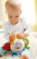 HABA Speelkussentje Regenboog Spelende baby